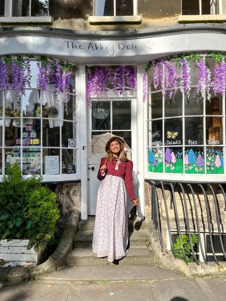 Dressed in Georgian and Bridgerton costume outside the Abbey Deli