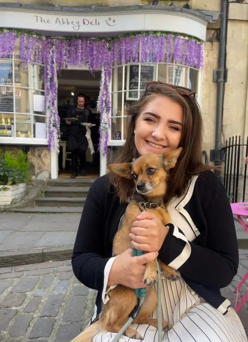 Dog sat outside the Abbey Deli in Bath