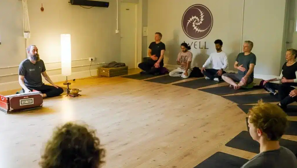 Practicing yoga and meditation in a class at Well Bath